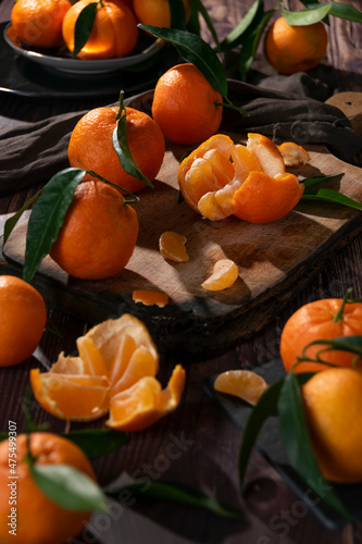 Fresh raw tangerine on dark background, healthy food ingredients