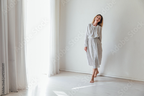 beautiful blonde woman in a light white portrait dress