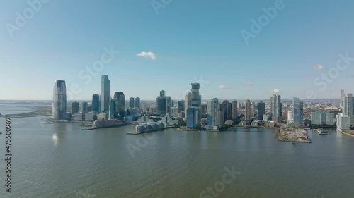 Wallpaper Mural Forwards fly above water. Panoramic shot of downtown buildings on riverbank. Modern tall skyscrapers. Jersey City, USA Torontodigital.ca