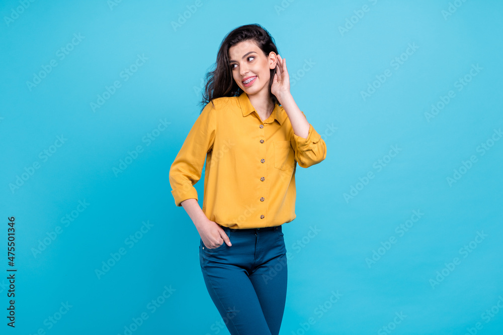 Photo of nice brunette hairdo millennial lady look empty space wear shirt trousers isolated on blue background Photo of nice brunette hairdo millennial lady look empty space wear shirt trousers isolated on blue background