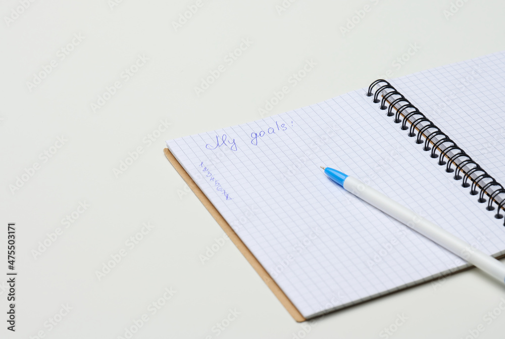 open blank notebook with pen on white table open blank notebook with pen on white table