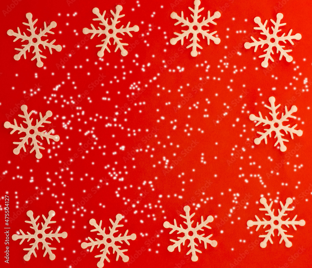 Christmas frame with white snowflakes on snow and red background Christmas frame with white snowflakes on snow and red background