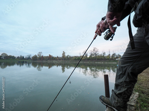 Tela Hands of a man catching a fish with a fishing rod at the lake