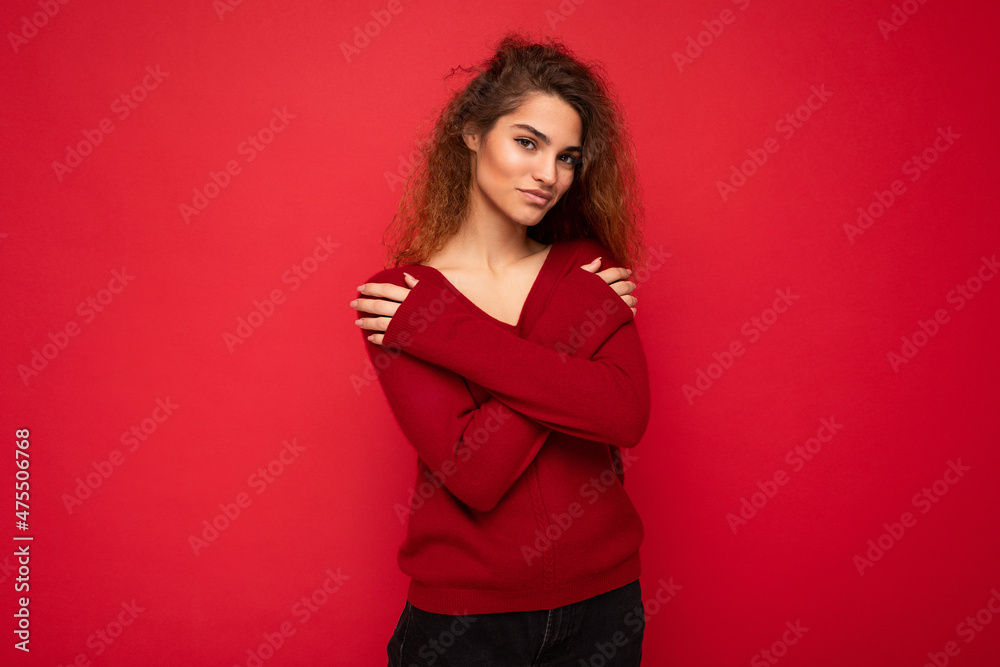 Young sexy beautiful curly brunet woman with sincere emotions isolated on background wall with copy space wearing casual trendy dark red sweater. Positive concept Young sexy beautiful curly brunet woman with sincere emotions isolated on background wall with copy space wearing casual trendy dark red sweater. Positive concept