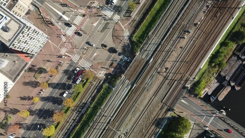 Infrastructure of Amsterdam train and tram and road in the city center. Aerial drone top down view. Crossroad intersection. photo