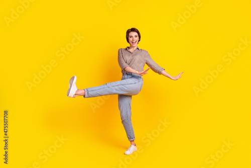 Full size photo of young cheerful girl have fun dancing party clubber isolated over yellow color background