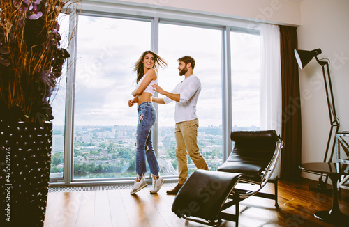 Storytelling image of a young couple moving in their new luxury apartment loft house. Concept about relationships and lifestyle
