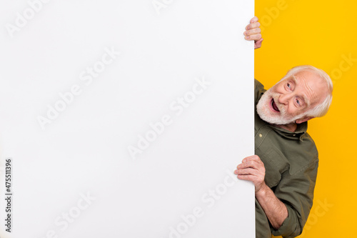 Photo of cool aged white hairdo man look promo wear khaki outfit isolated on yellow color background photo