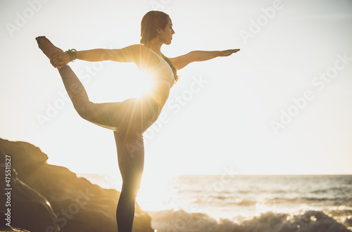 Canvas Print Image of a beautiful young woman making yoga training and meditation on the beach and rocks at baker beach in san francisco