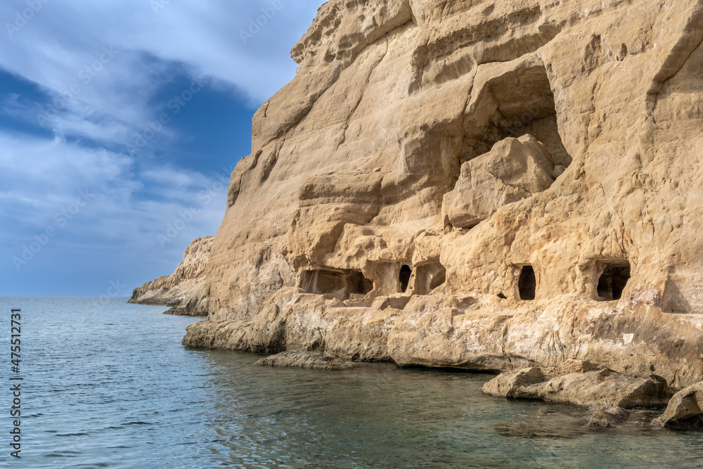 Stunning neolithic era caves on the cliff of Matala beach, Southern Crete, Greece. Used as historically used as living spaces and tombs