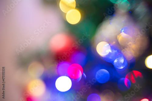 Defocused background. Christmas tree with balloons and garlands.