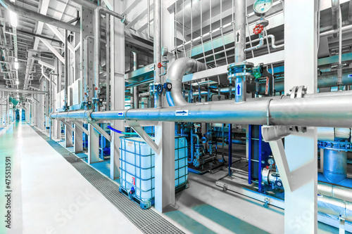 Photo of pipes and tanks. Chemistry and medicine production. Pharmaceutical factory. Interior of a high-tech factory, modern production. Blue tone © Ivan Traimak