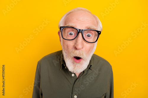 Photo of astonished aged person open mouth look speechless camera isolated on yellow color background
