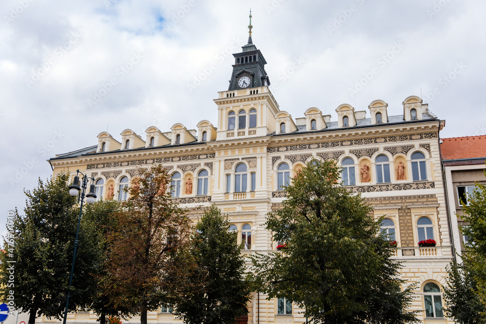 Louny, Czech Republic, 19 September 2021: Neo-Renaissance town hall at main Peace square or Mirove namesti, building with sgraffito mural and clock tower and sculptures allegories on autumn day