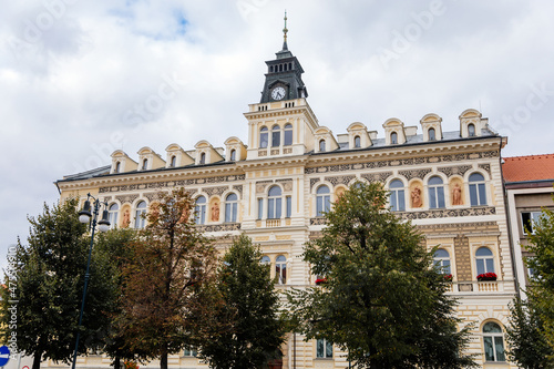 Louny, Czech Republic, 19 September 2021: Neo-Renaissance town hall at main Peace square or Mirove namesti, building with sgraffito mural and clock tower and sculptures allegories on autumn day photo