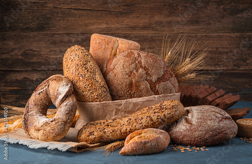 Assortment of rye and wheat bread on a wooden background.