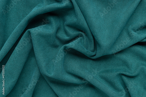 elegance green fabric texture with folds. wavy cloth background. Textile and texture concept