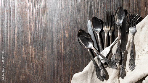 Many different vintage  cutlery  forks, knifes, spoons on  wooden background. Large inage for banner with copy space photo