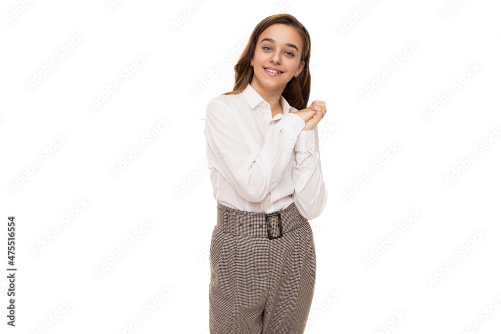 Photo of a beautiful and cute brunette girl with long hair in a white blouse and pants in a cage who smiles and stands isolated on a white background Photo of a beautiful and cute brunette girl with long hair in a white blouse and pants in a cage who smiles and stands isolated on a white background