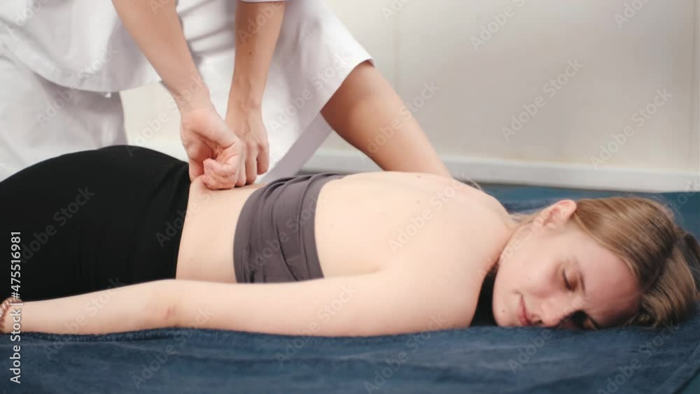 Young woman getting professional back chinese massage in spa salon Young woman getting professional back chinese massage in spa salon