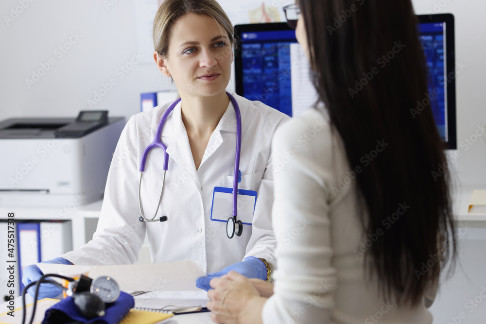 Patient on appointment explain problem to medical worker in clinic Patient on appointment explain problem to medical worker in clinic