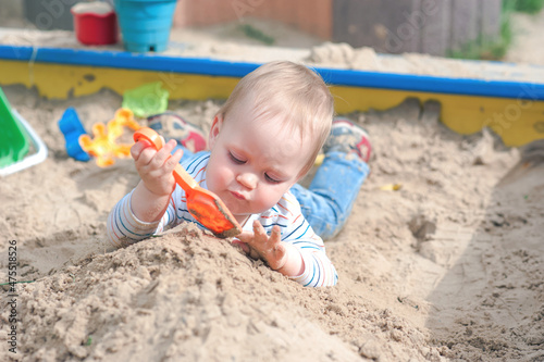 Toddler activity on playground in sandbox..