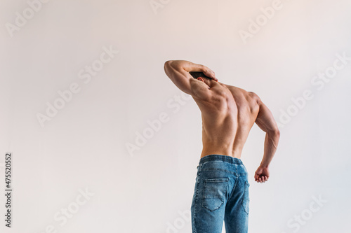 young man, brutal appearance, with a beautiful torso, bodybuilder, in the studio on a white background, BW photo