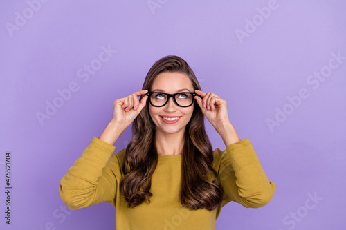 Portrait of gorgeous cheerful person look interested up empty space isolated on violet color background