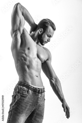 young man, brutal appearance, with a beautiful torso, bodybuilder, in the studio on a white background, BW photo