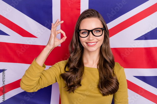Photo of attractive positive lady show okey symbol approve feedback rate isolated on british flag background