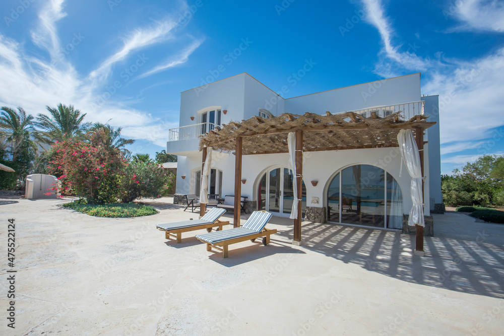 Exterior of luxury villa in tropical resort with patio area - obrazy, fototapety, plakaty 