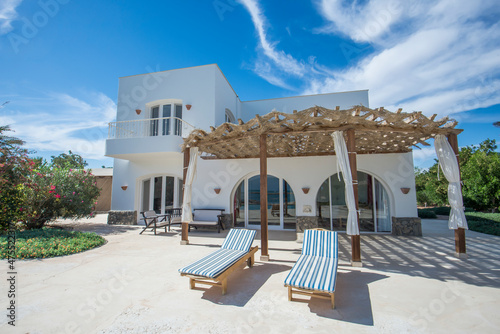 Exterior of luxury villa in tropical resort with patio area © Paul Vinten