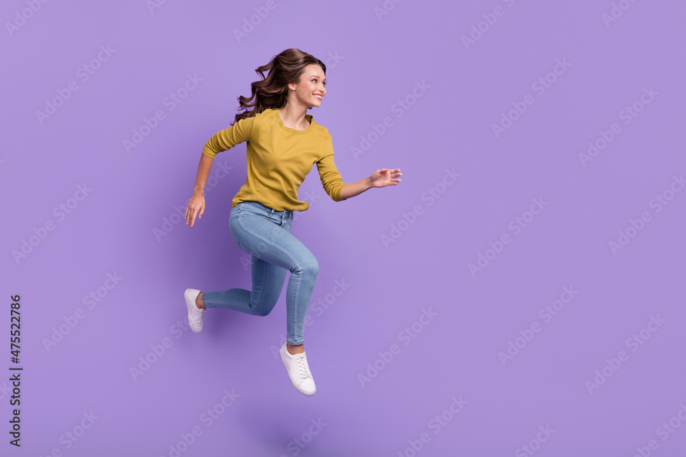 Full body profile photo of cheerful pretty lady look empty space run fast isolated on purple color background