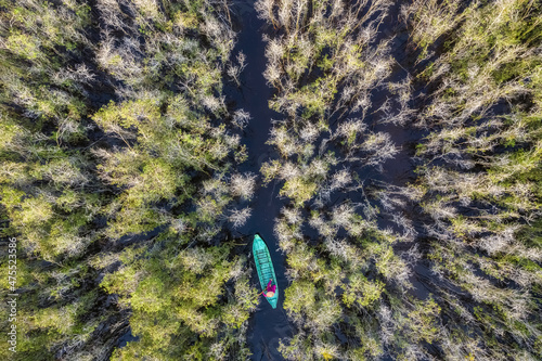 Aerial view of woman climbs a boat in Tram Chim National Forest, Dong Thap, V...