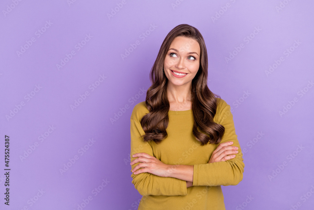 Portrait of pretty charming person folded arms look interested empty space isolated on purple color background Portrait of pretty charming person folded arms look interested empty space isolated on purple color background