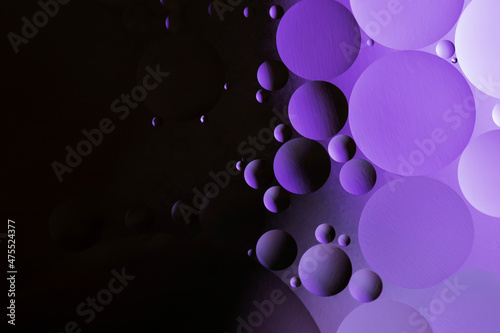 Trendy Color of the year 2022 Very Peri. Colorful abstract background. Lilac circles and oil bubbles in the water. Close up. Macro abstraction. Rainbow oil pattern and texture.