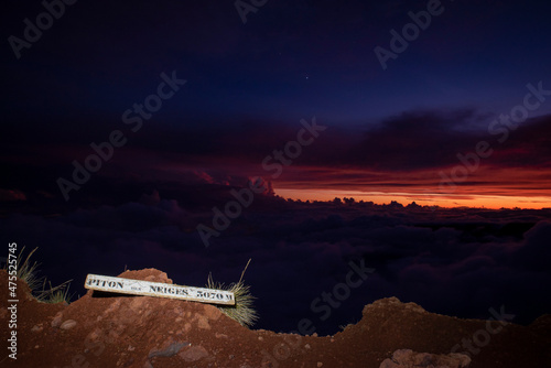 Sunset at Piton des Neiges summit with summit name, Reunion island, France