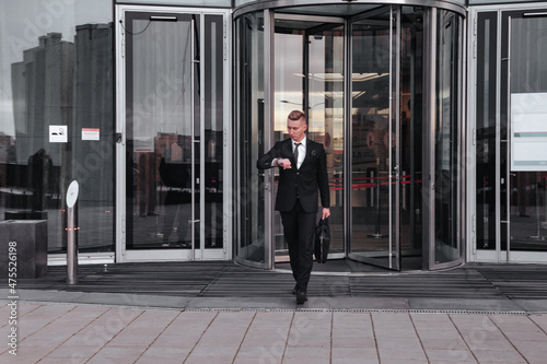 Portrait young man businessman with briefcase background business building © Alex Vog