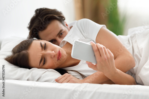 Jealous Husband Reading Unfaithful Wife's Messages While She Texting Indoor photo