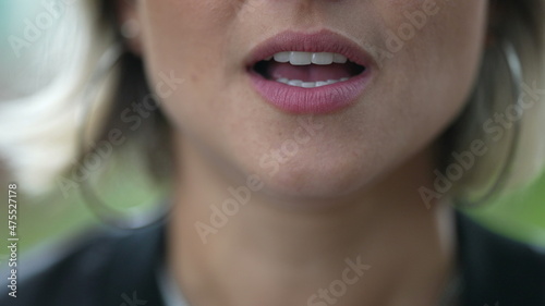 Woman mouth speaking to camera. Girl lips close-up lips talking photo