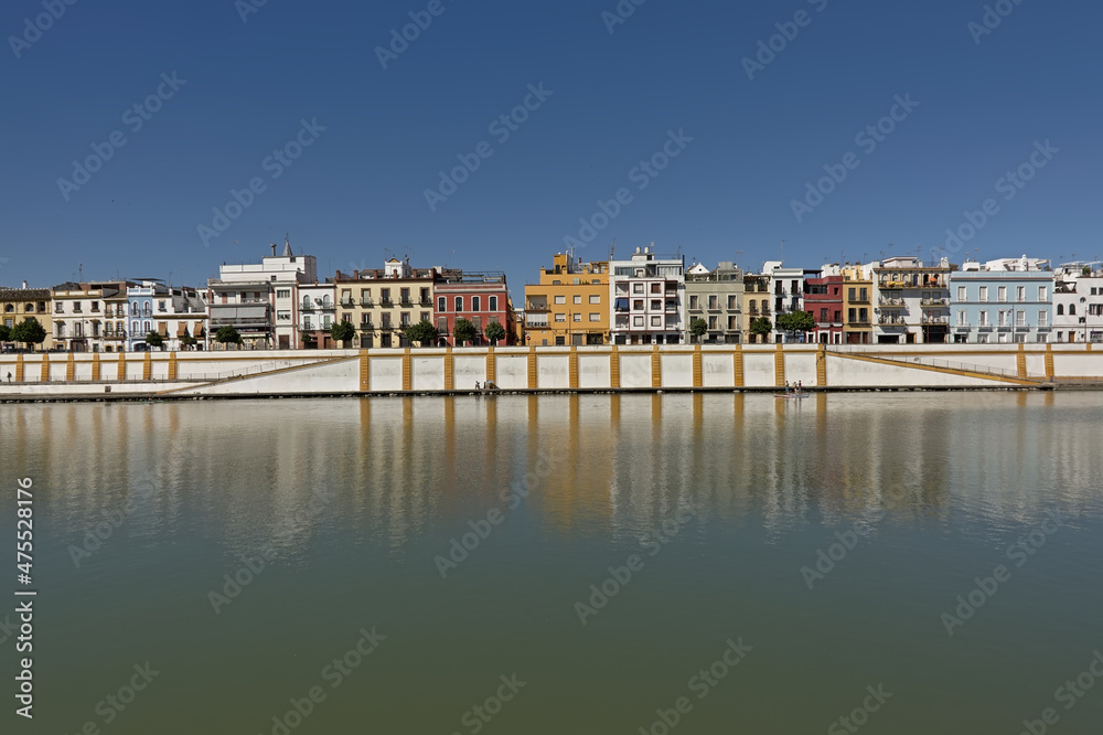 Quay of Guadalquivir river with colorful traditional houses of Triana district, Seville, Andalusia, Spain
