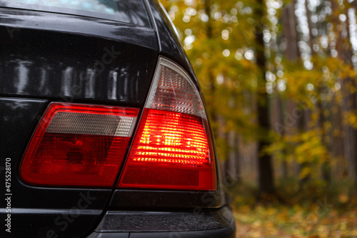 Rear end close up BMW E46 red car lights.