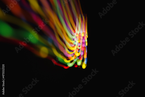 Colored lines of light on a black background.