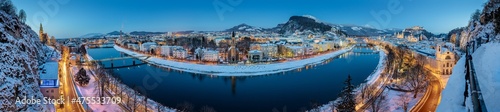 Breathtaking panorama view of the snow-covered city of Salzburg in the evening, Austria