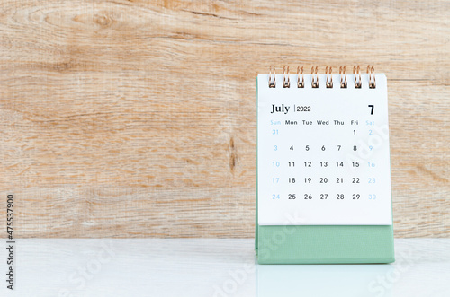 July 2022 desk calendar on white table.