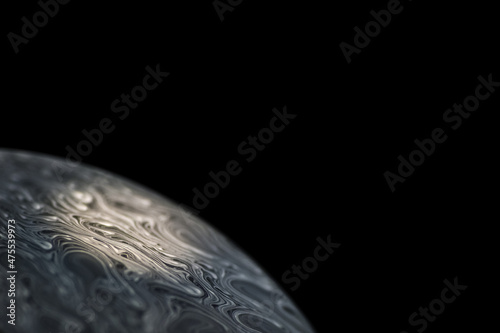 Grey colored cold alien planet, spotlighted by the sun with an atmosphere in universe on dark background. Soap bobble