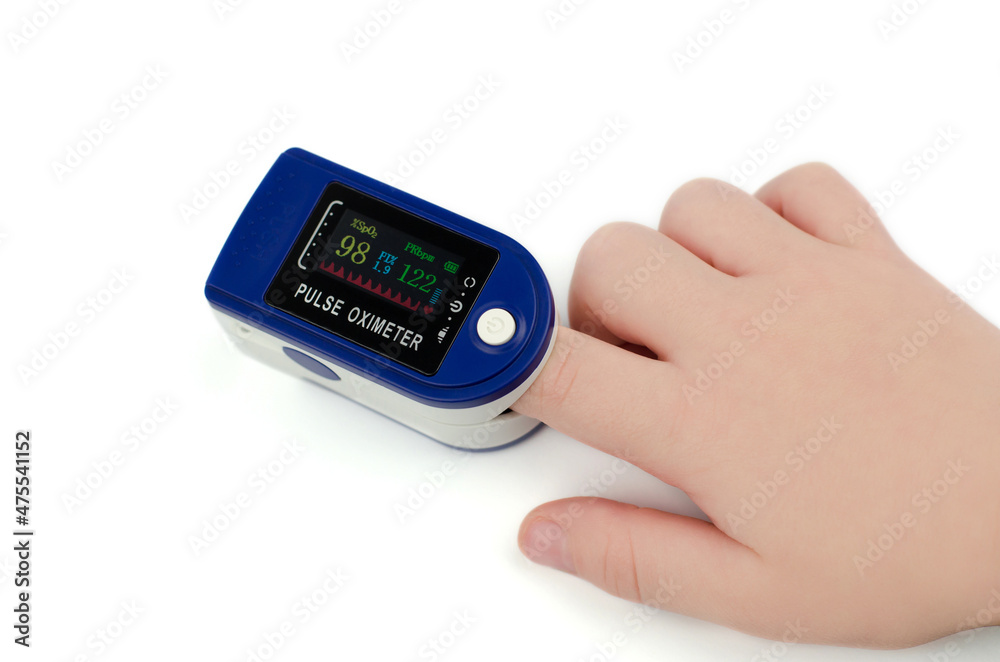 Pulse oximeter on a child's finger on a white background. Saturation 98 and pulse 122 in a child