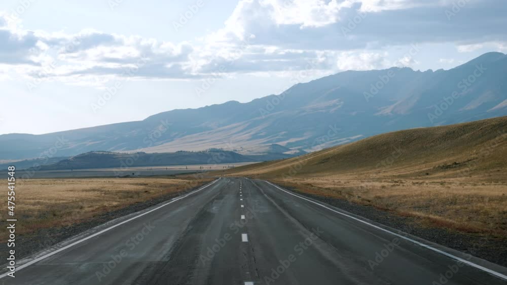 Driving On An Empty Highway In The Hilly Mountains And Dried Desert Driving On An Empty Highway In The Hilly Mountains And Dried Desert