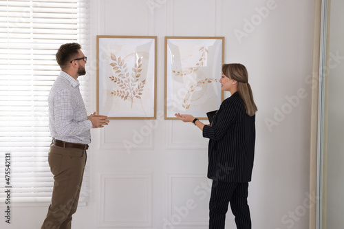 People viewing exposition in modern art gallery