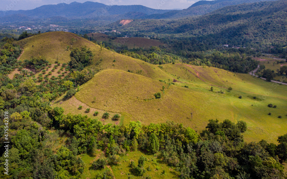 bald mountain or Phu Khao Ya with green grass field and blue sky. One of natural travel attraction in Ranong province, Thailand